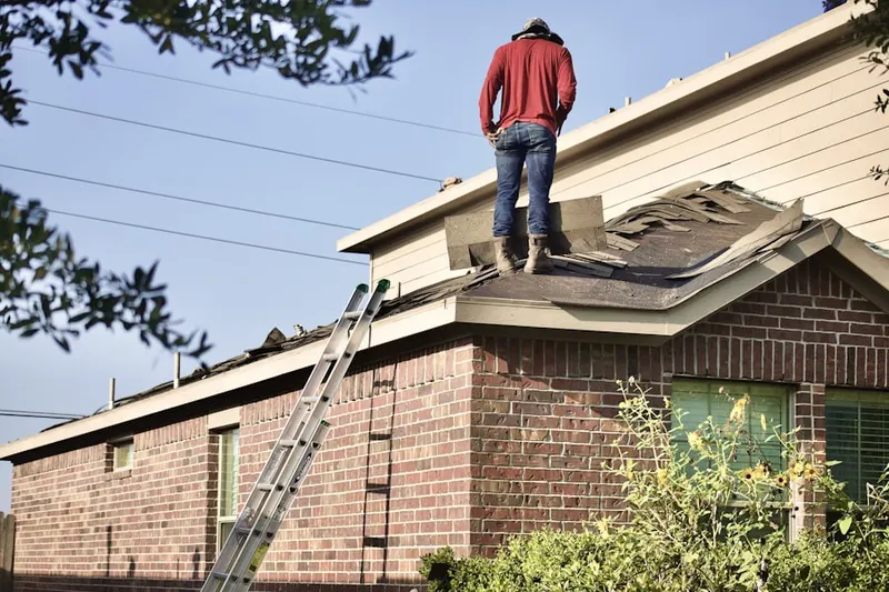 Professional roofer working on a residential roof in Overlook Estates